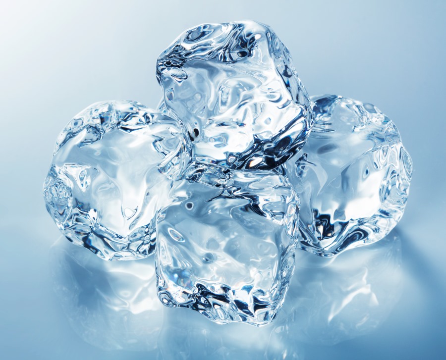 Heap of blue ice cubes on blue background